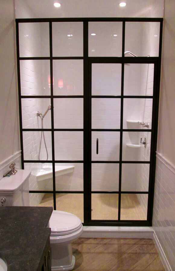 shower with glass window paneling white tiled walls and a bench