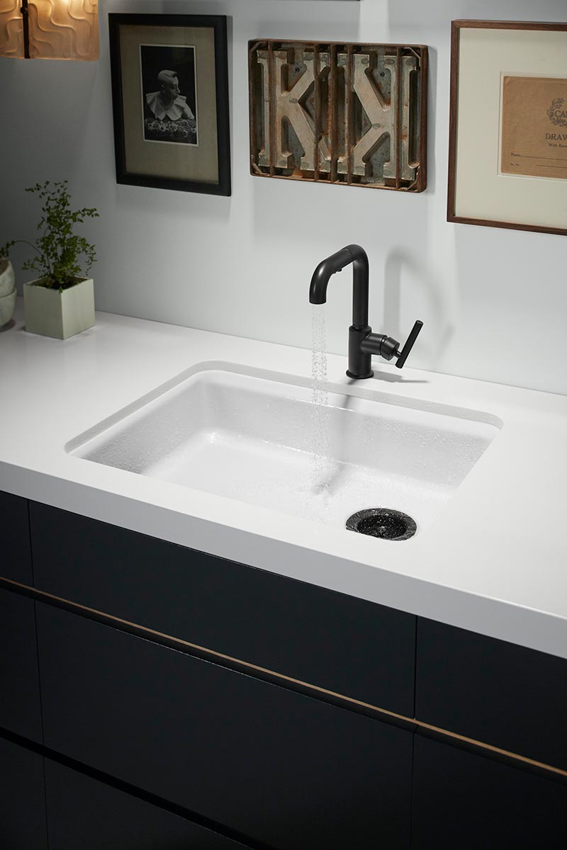 white sink with dark metal faucet
