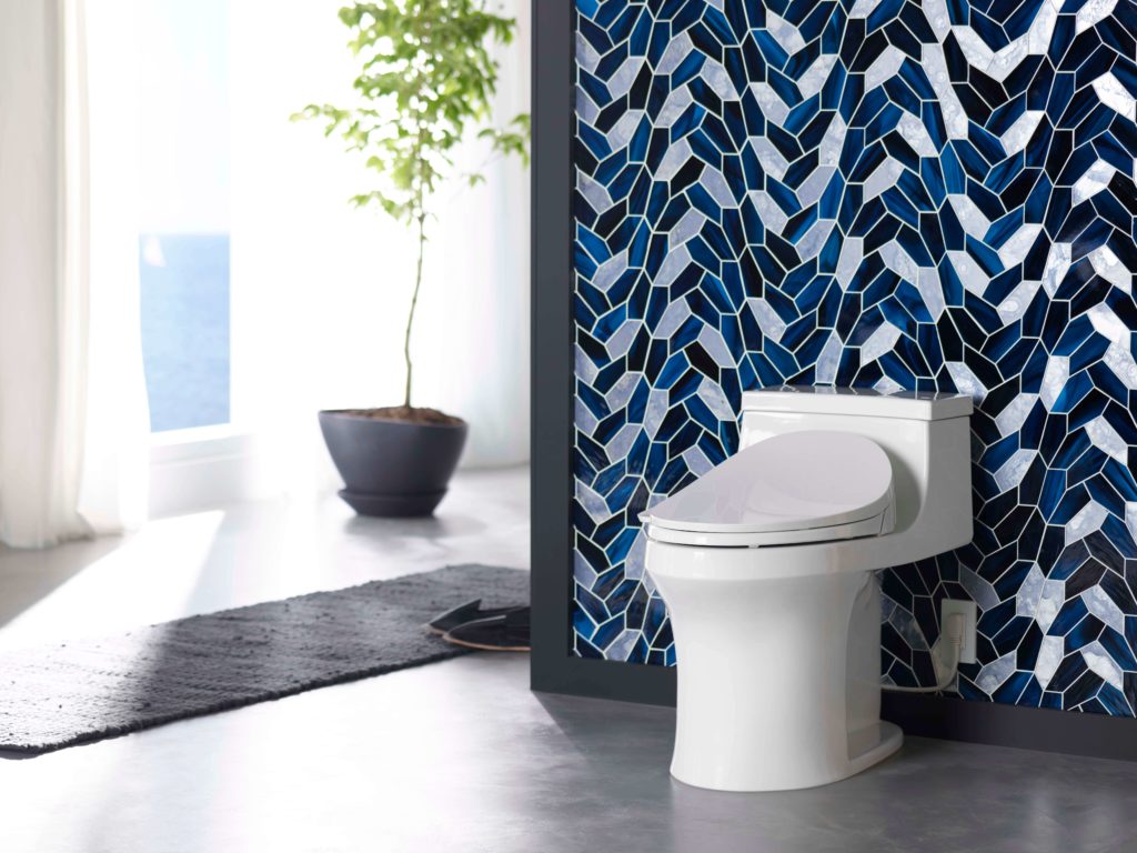 white toilet with blue mosaic wall