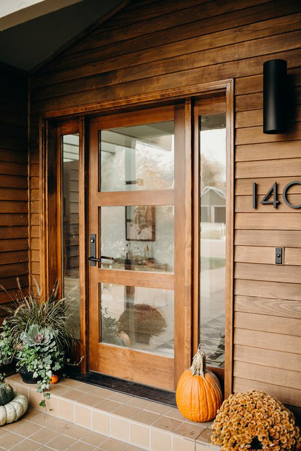 dark wood entry door with three glass panels