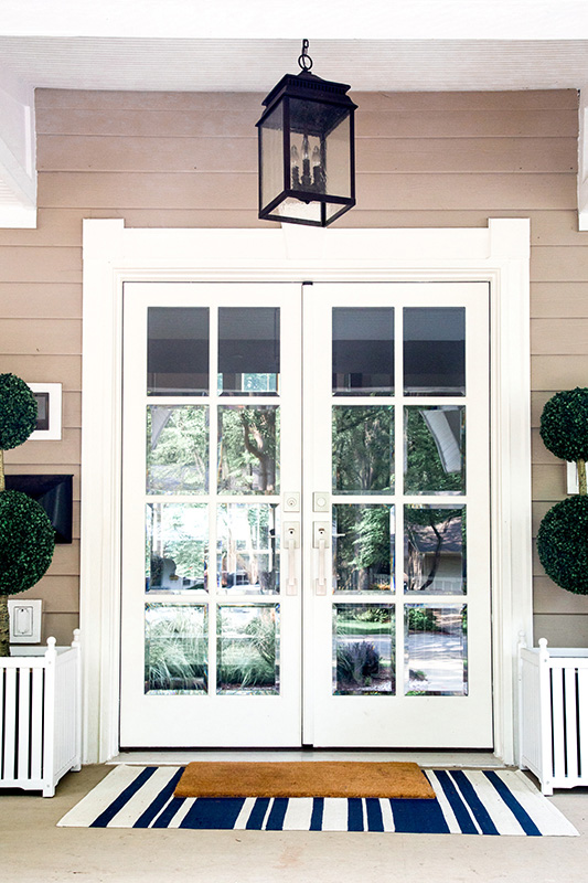 white entry door with tan welcome mat